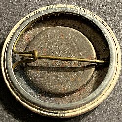 Reverse of pin-back encased